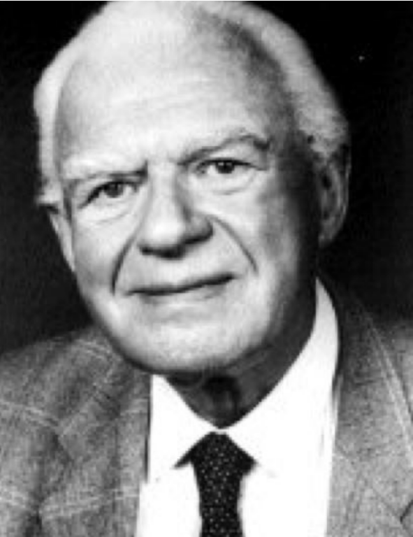 A black and white photo of a man in a suit and tie.