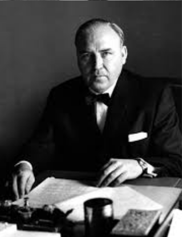 A man in a suit sitting at a desk.