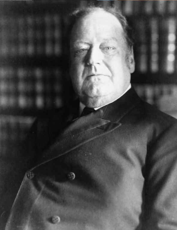 A black and white photo of a man in a suit.