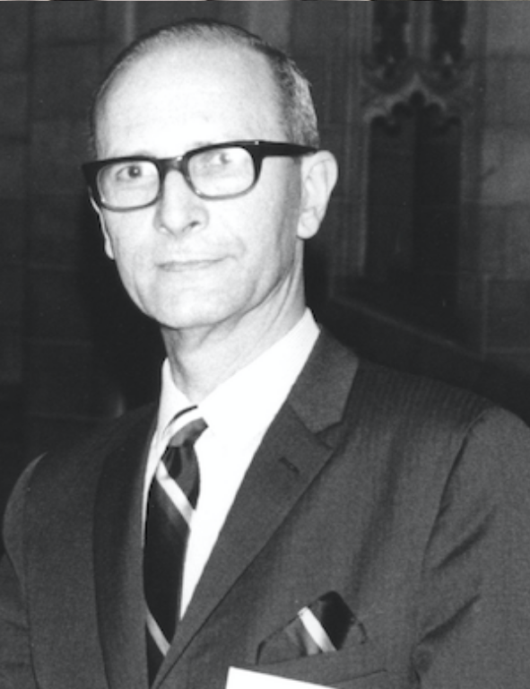 A black and white photo of a man in a suit and tie.