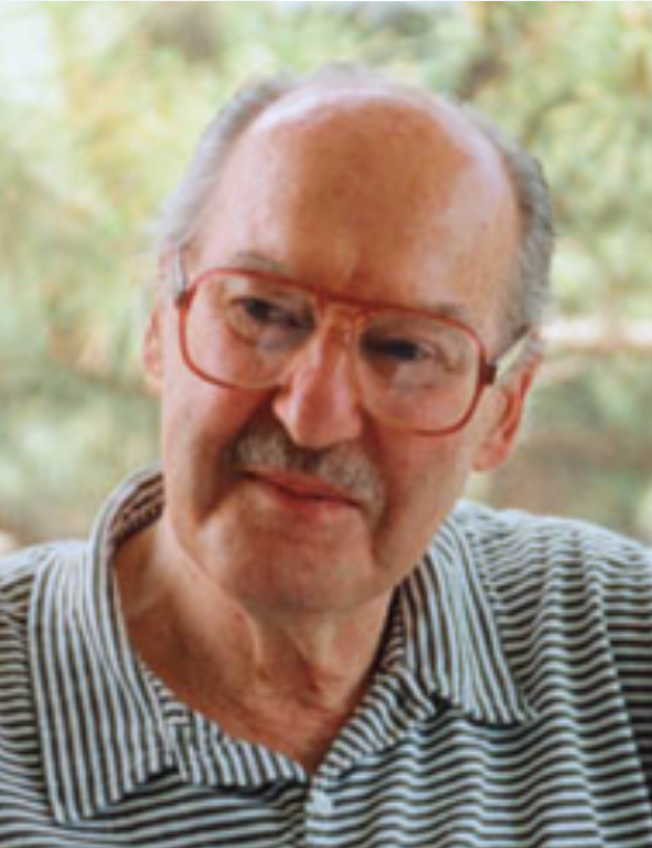 An older man wearing glasses and a striped shirt.