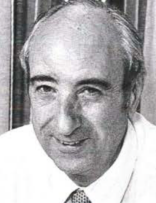 A black and white photo of a man in a tie.