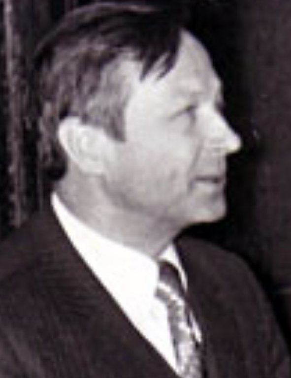 A black and white photo of a man in a suit.