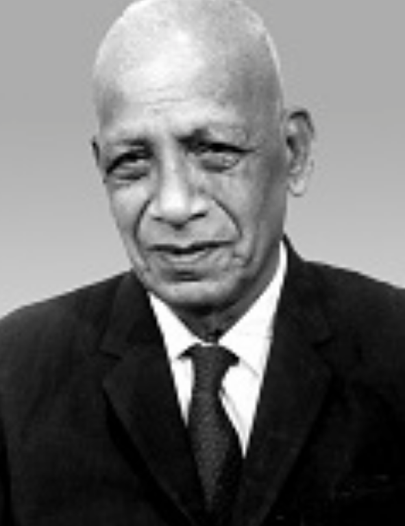 A black and white photo of a man in a suit.