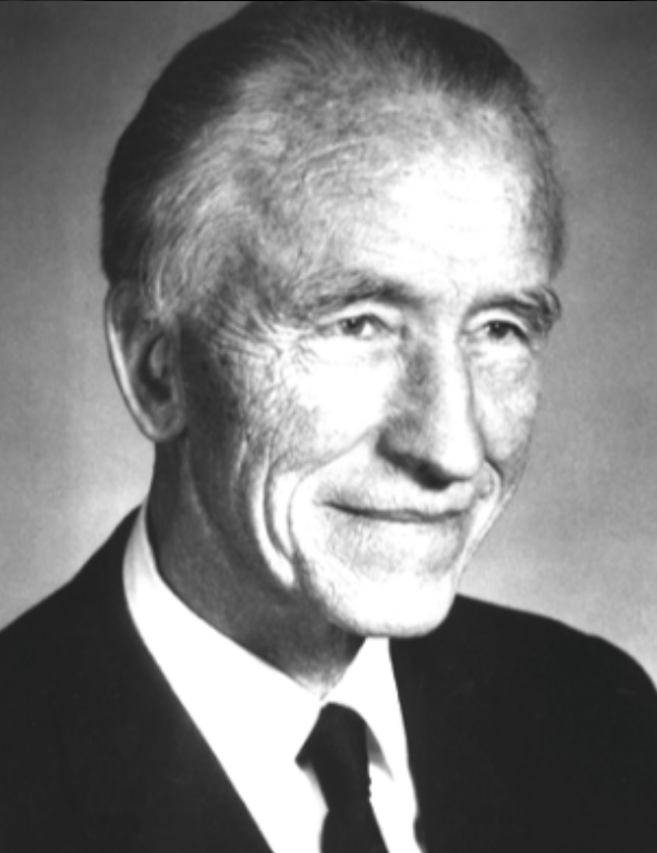 A black and white photo of a man in a suit and tie.