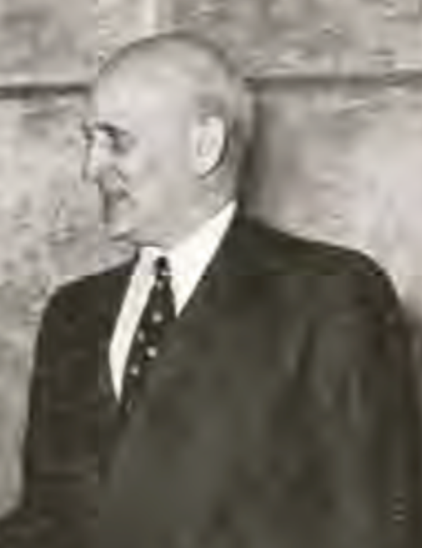 A black and white photo of a man in a suit.