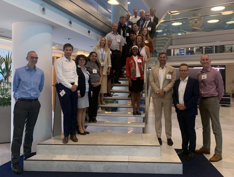 A group of people standing on stairs in an office building.