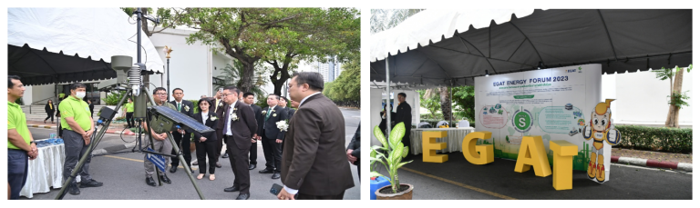 Group of people examining outdoor broadcasting equipment next to a tent with a sign for an energy forum event.