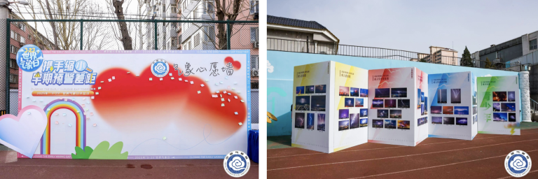 Two large outdoor displays: one with colorful graphics and a rainbow theme, the other featuring multiple photographs. Both are set up on a sports track near buildings and trees.