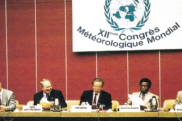 Five people sit at a panel table beneath a "XII Congrès Météorologique Mondial" sign.