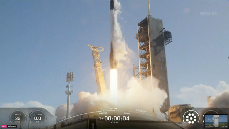 A rocket is launching from a pad, producing flames and smoke, with a clear blue sky in the background. On-screen displays show speed, altitude, and a countdown timer.