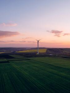 Wind turbines in a rural landscape at sunset.