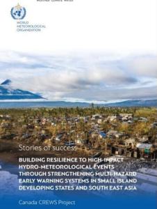 Cover of a report titled "Stories of Success" featuring a coastal village with damage to buildings and trees, with a mountain and cloudy sky in the background.