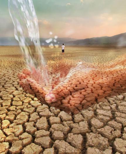 A pair of hands catching flowing water is superimposed over a barren, cracked desert landscape with a solitary person in the background.