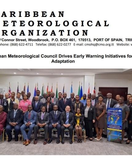 Group photo of the Caribbean Meteorological Organization's 67th council, featuring numerous participants standing and seated, with flags in the background.