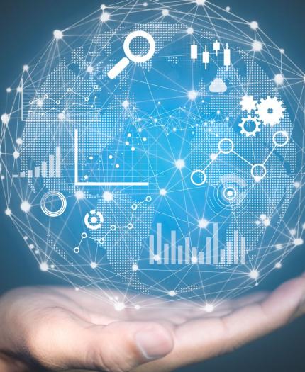 A hand holds a digital globe with interconnected icons and graphs representing data analytics, technology, and global connectivity on a blue background.