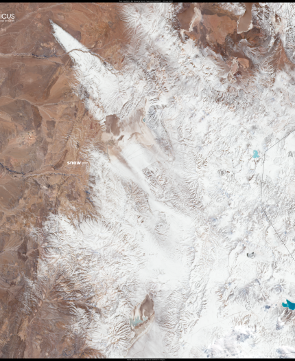 Satellite image showing the snow-covered Andes mountains between Chile and Argentina, with the Atacama Desert visible on the left side of the image. Copernicus and EU logos are present.