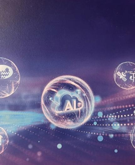 A digital graphic shows a central "AI" icon surrounded by four circular icons representing business, healthcare, engineering, and communication, on a purple abstract background.