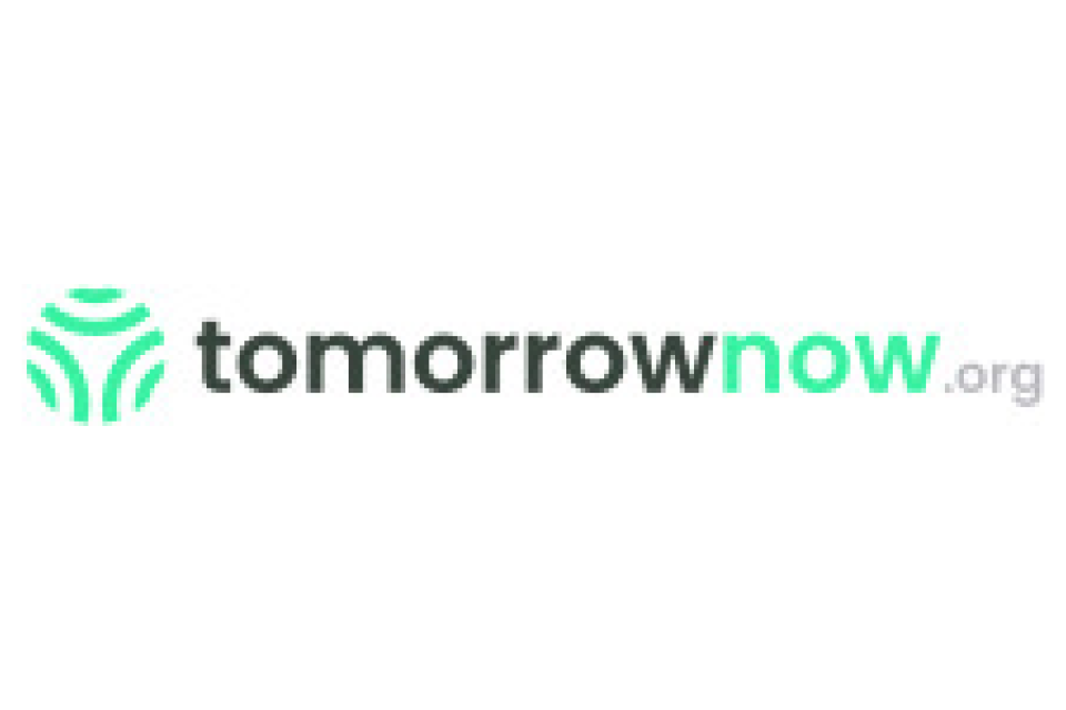 Logo with a green circular geometric design on the left and the text "tomorrownow.org" in gray and green to the right.